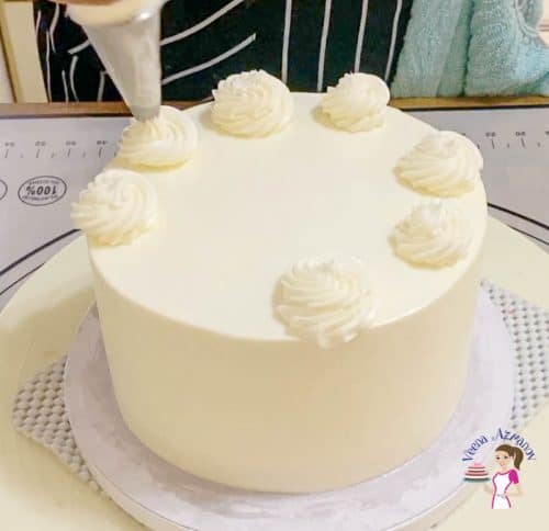Pipe swirls on the cake with remaining frosting
