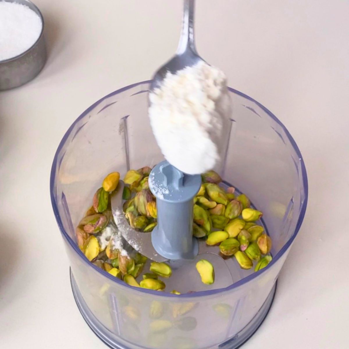 Grind pistachios with flour in food processor.