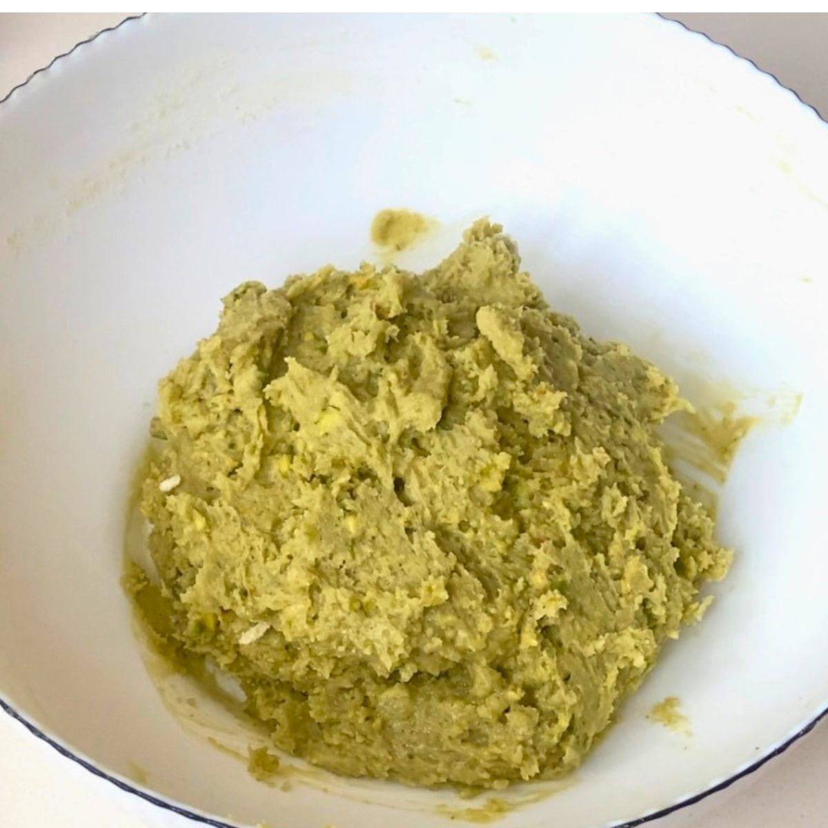 A pistachio cookie dough in the white bowl.