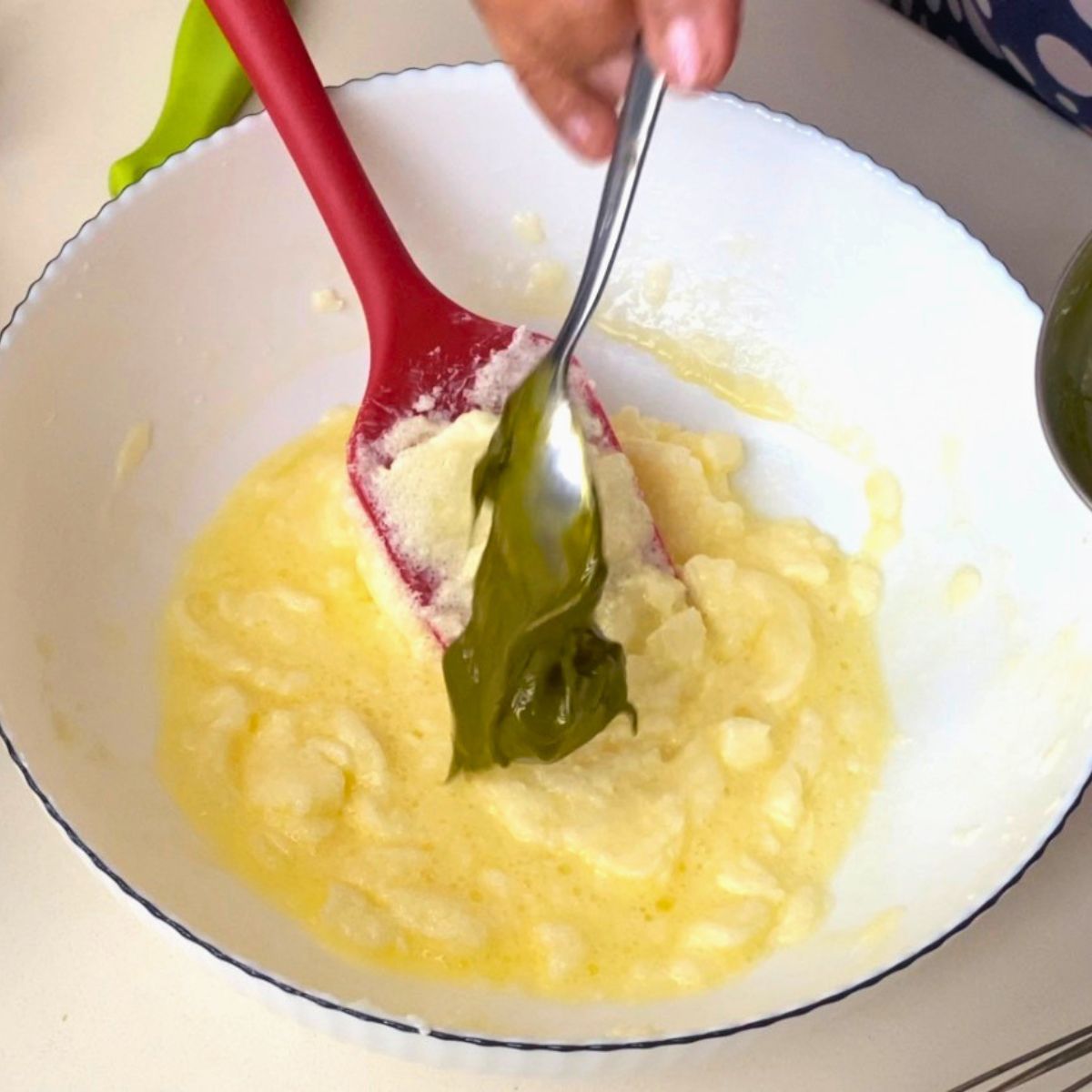 Adding pistachio paste to the sugar, butter and egg.
