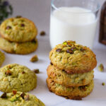 Pistachio cookies are stacked on the table.