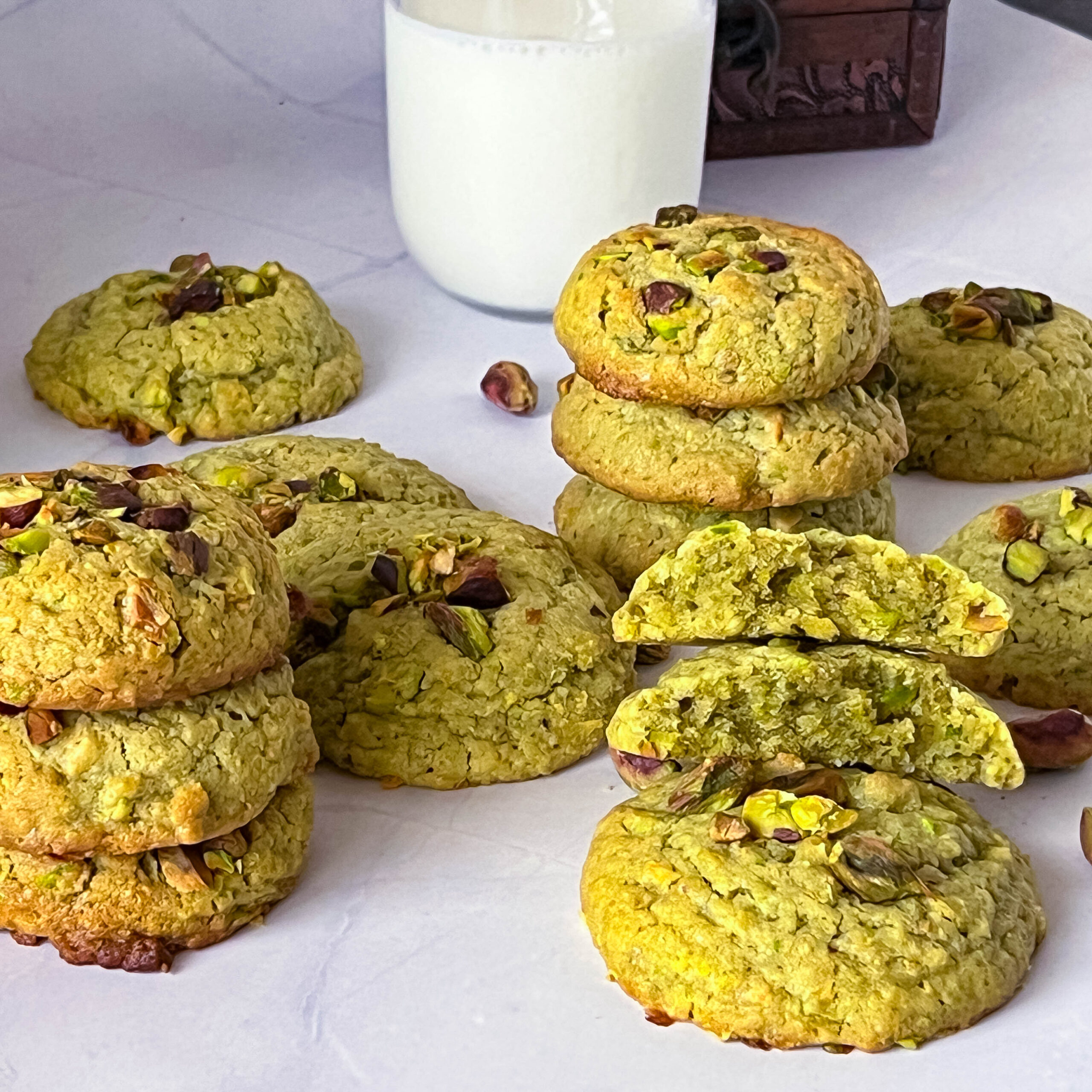 A stack of pistachio cookies on the table.