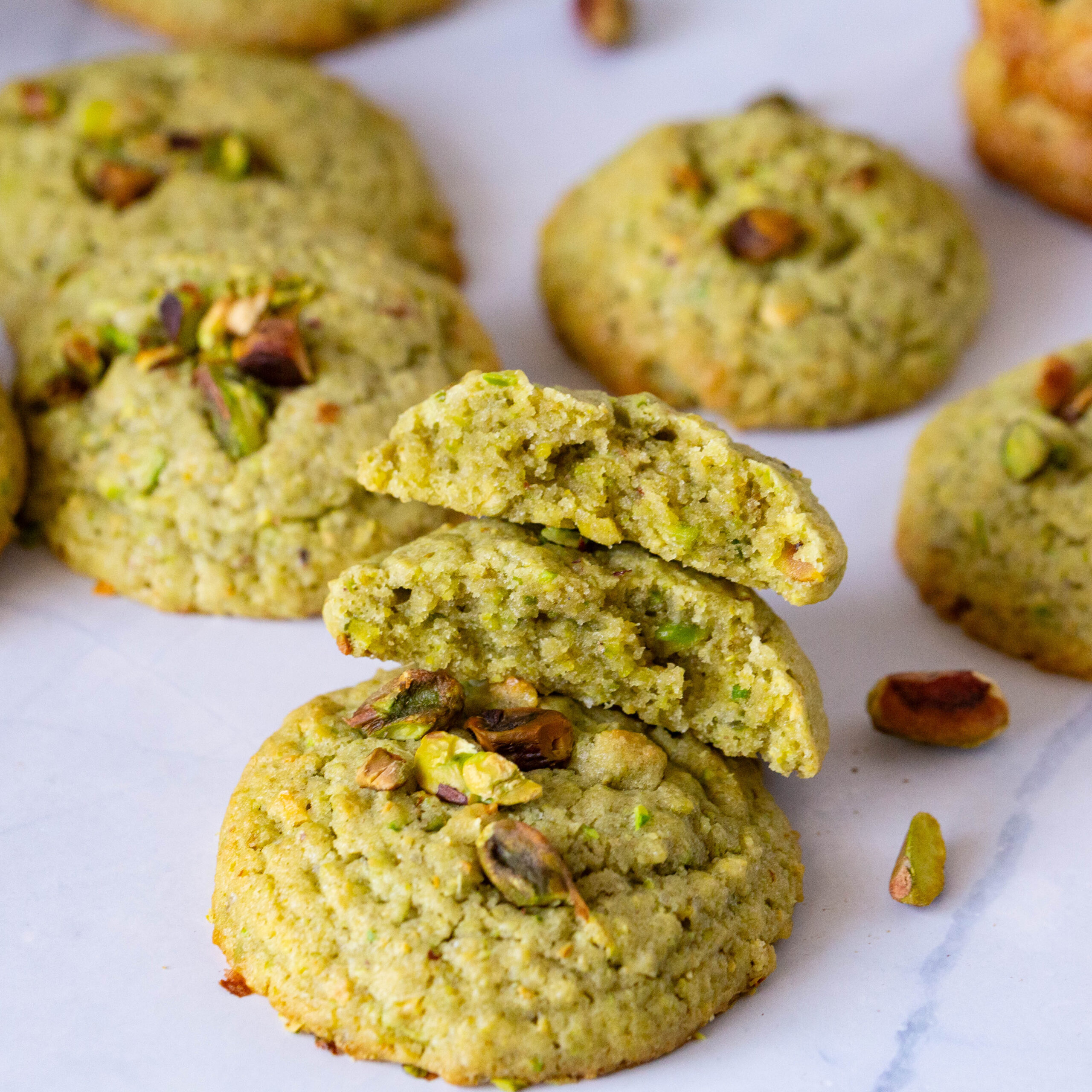 Stack of pistachio cookies on the table.