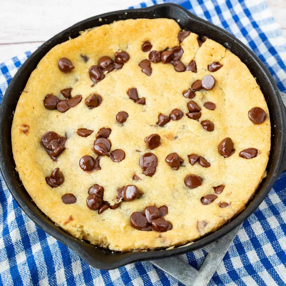 A skillet with fresh baked chocolate chip cookie.