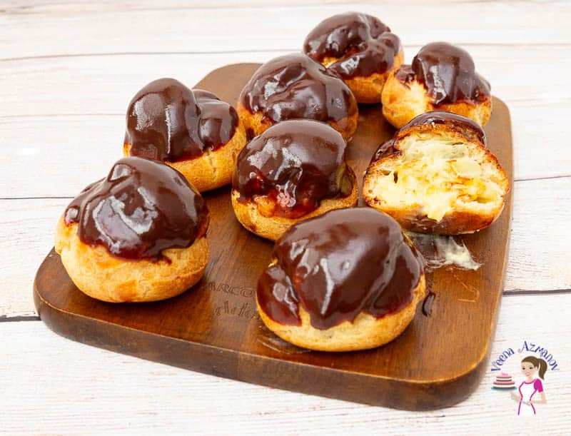 Profiteroles on a wooden board.