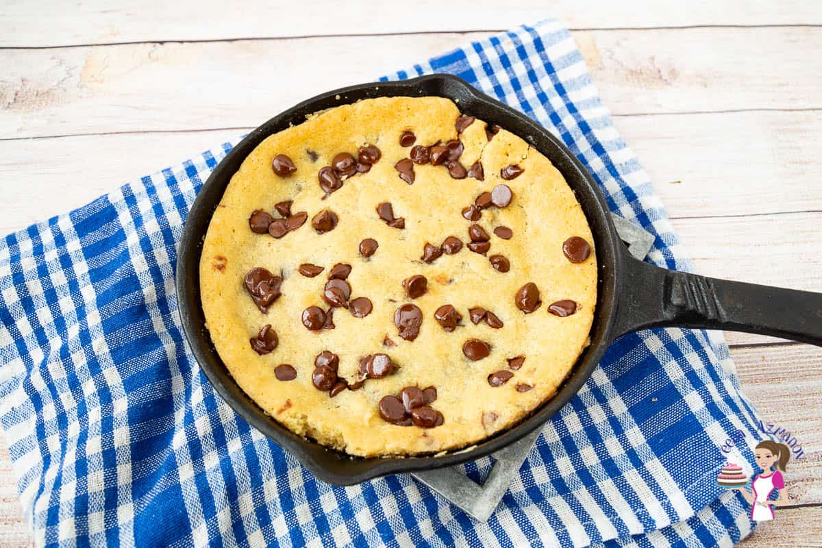 A giant chocolate chip cookie in a skillet.