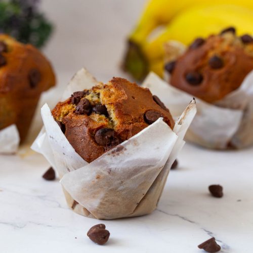 Muffins with banana and chocolate chips on the table.