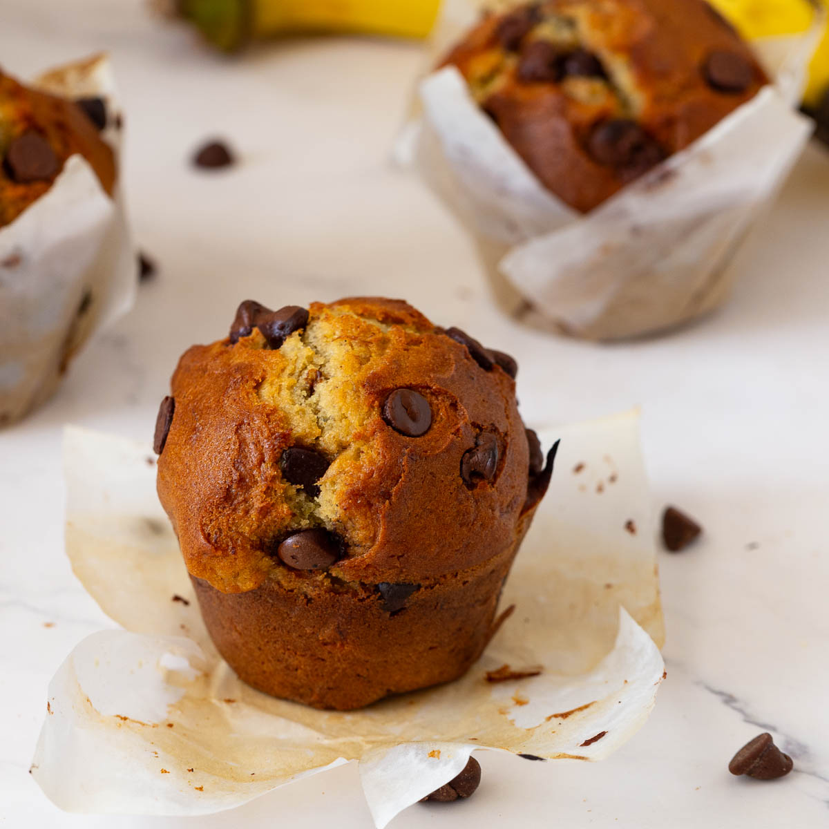 Bakery banana muffins with chocolate chips on the table.