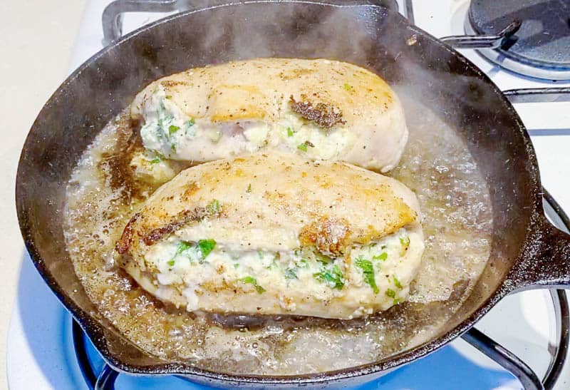 Cook the stuffed chicken breast on a skillet