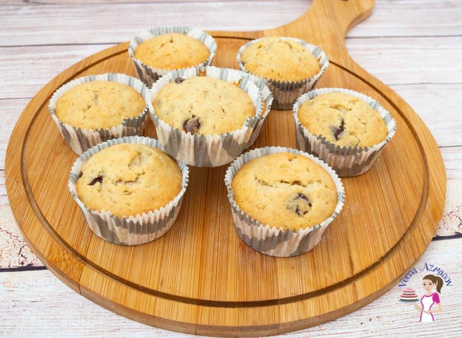 Chocolate chip banana muffins on a wooden board.