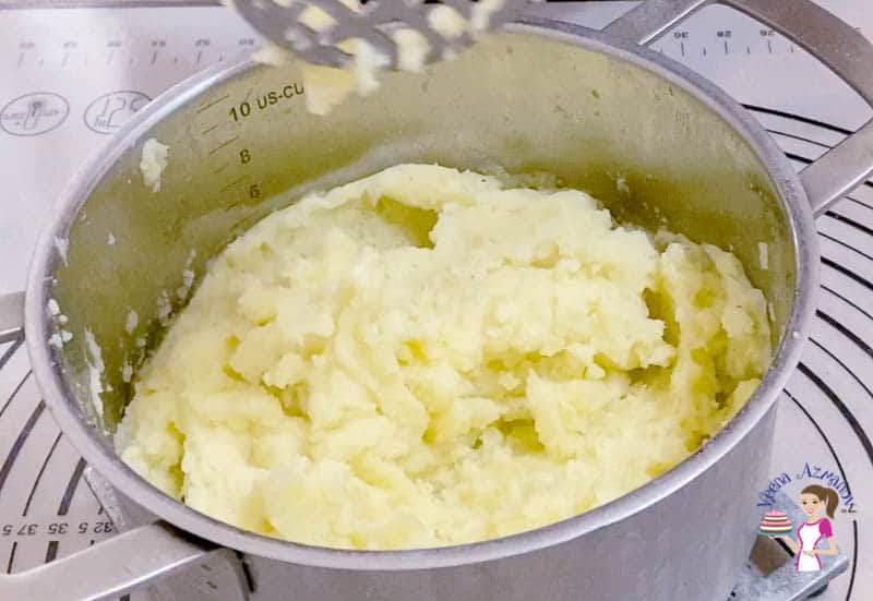 Mash the potatoes for the meat pie