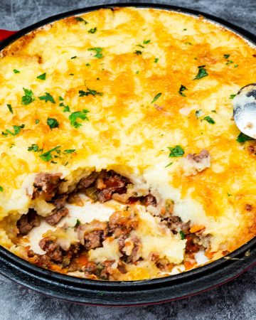 A skillet with ground beef with mashed potatoes.