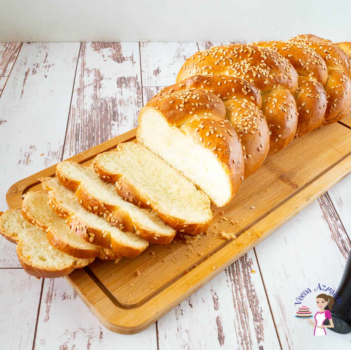 Sliced Challah bread on a wooden board.