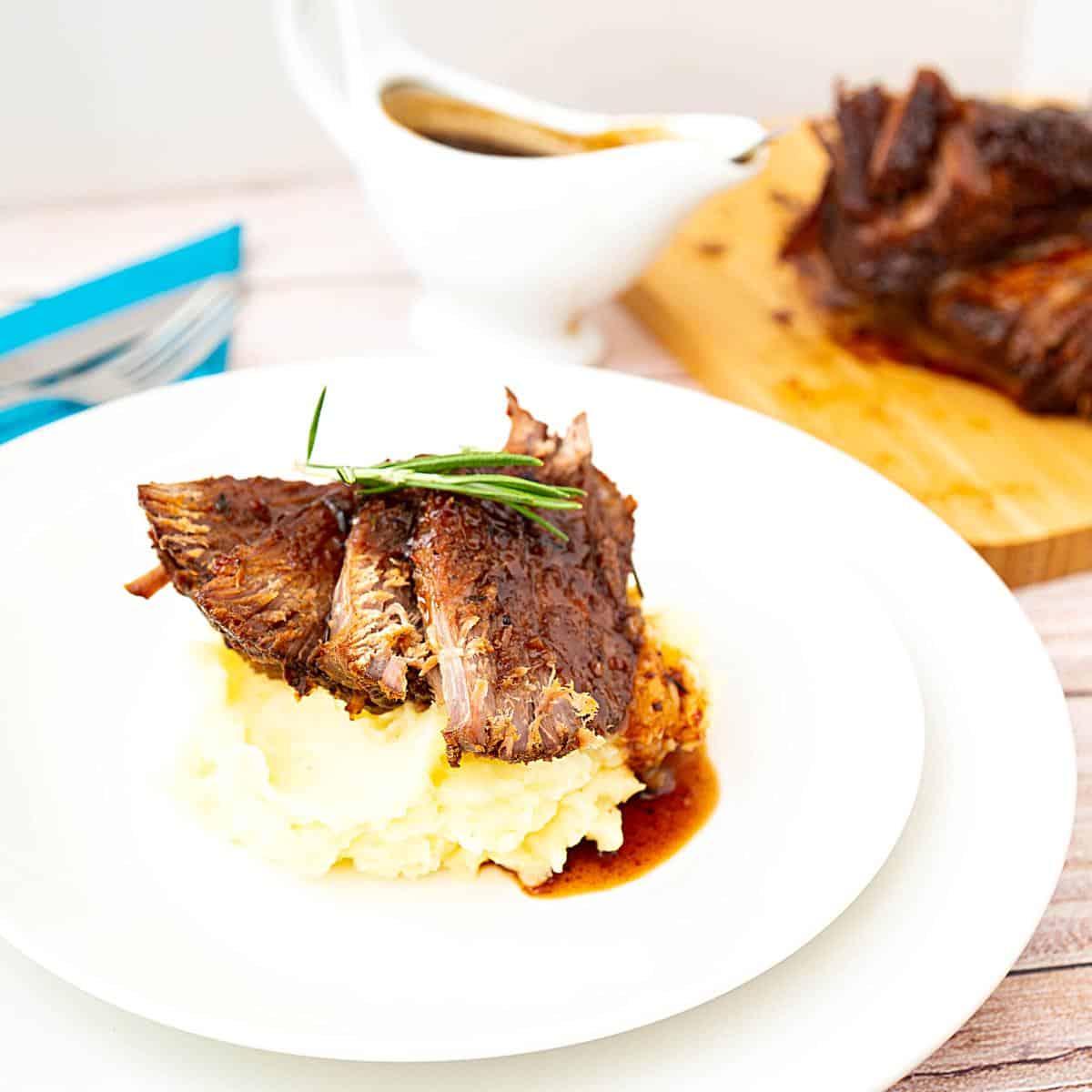 A plate with mashed potato and brisket.