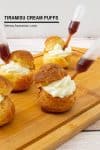 Tiramisu cream puffs on a wooden tray.