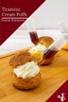 Tiramisu cream puffs on a wooden tray.