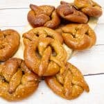 A stack of whole wheat Pretzels on a wooden table.