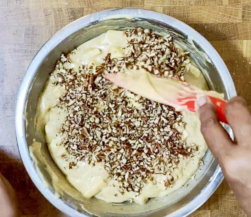 Add the chopped pecans to the apple cake batter
