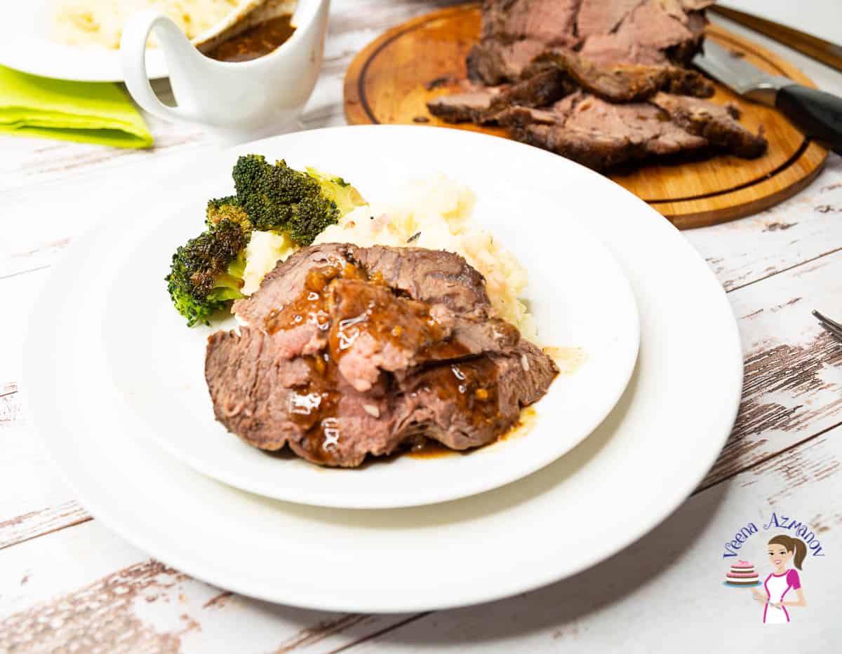 A plate of Roast beef with Broccoli and mashed potatoes.