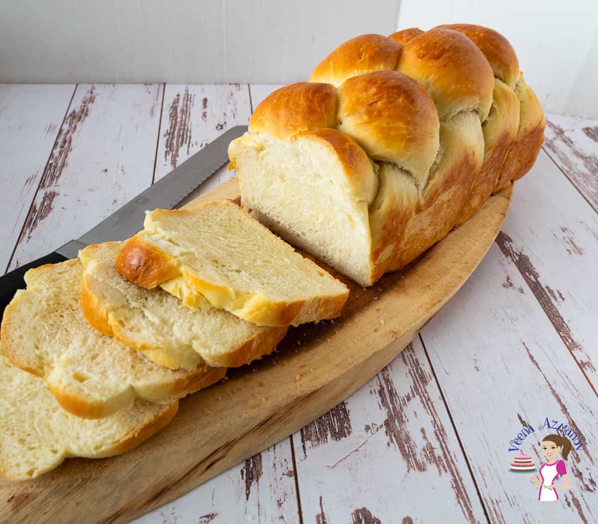 sliced challah bread on a wooden tray