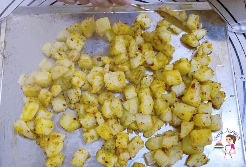 Pour potatoes on an oil baking tray