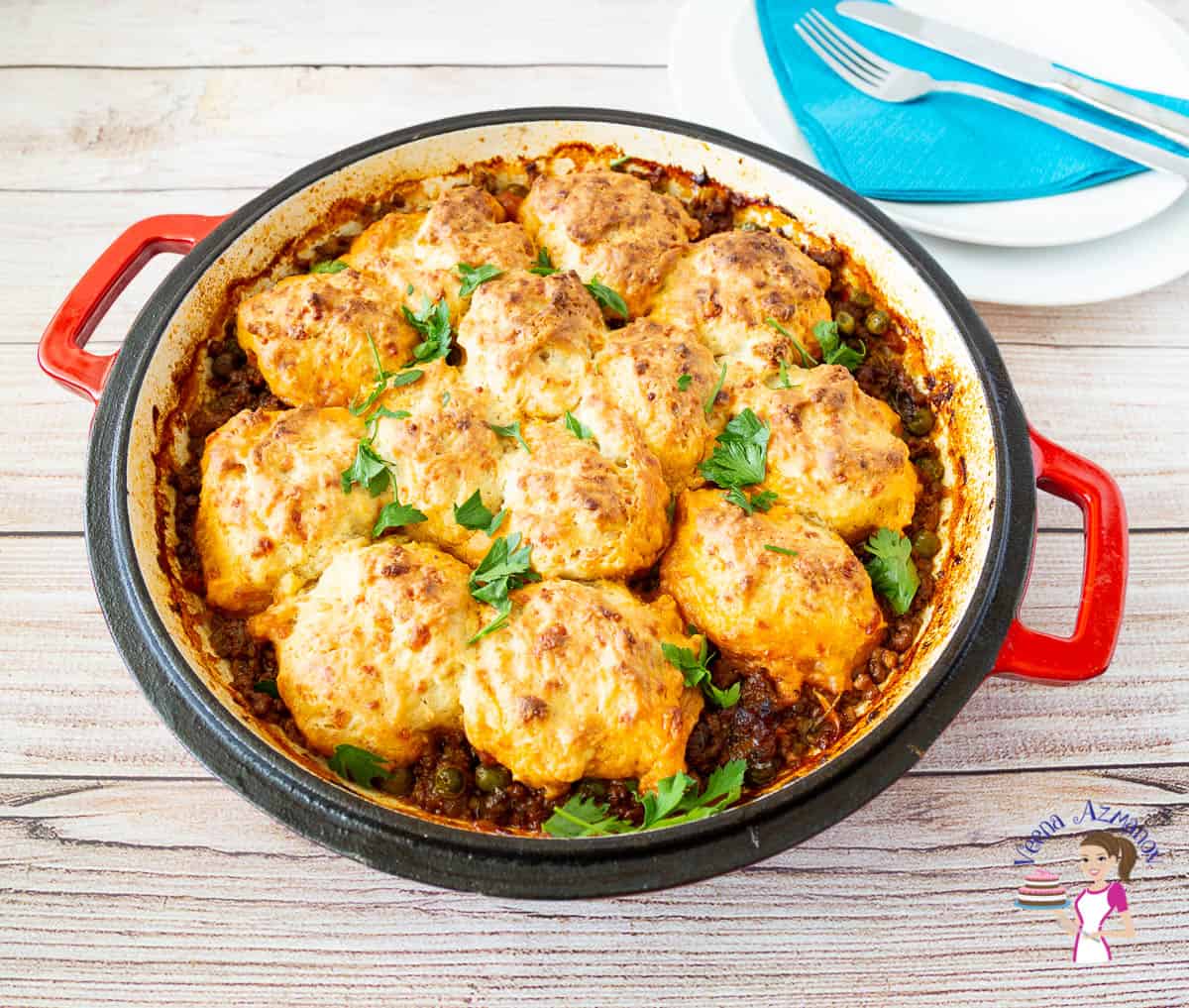 A skillet with beef casserole with cheddar biscuits
