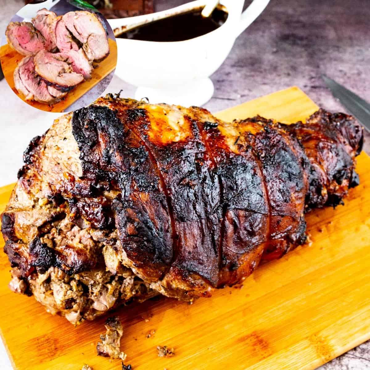 A leg of lamb on a wooden board.