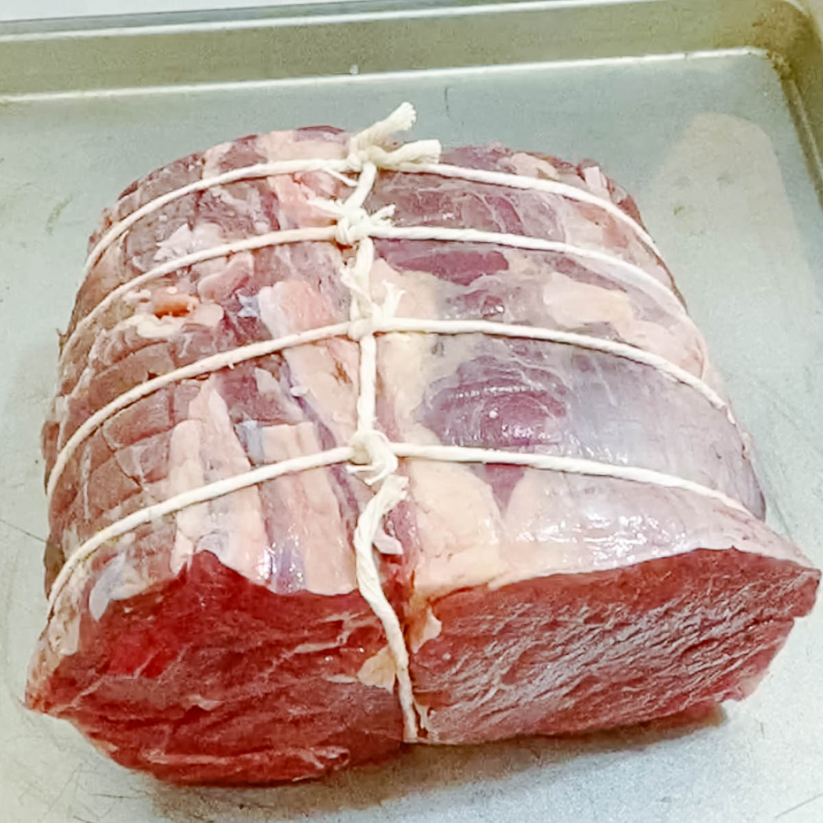 A beef chuck tied with a kitchen twine.