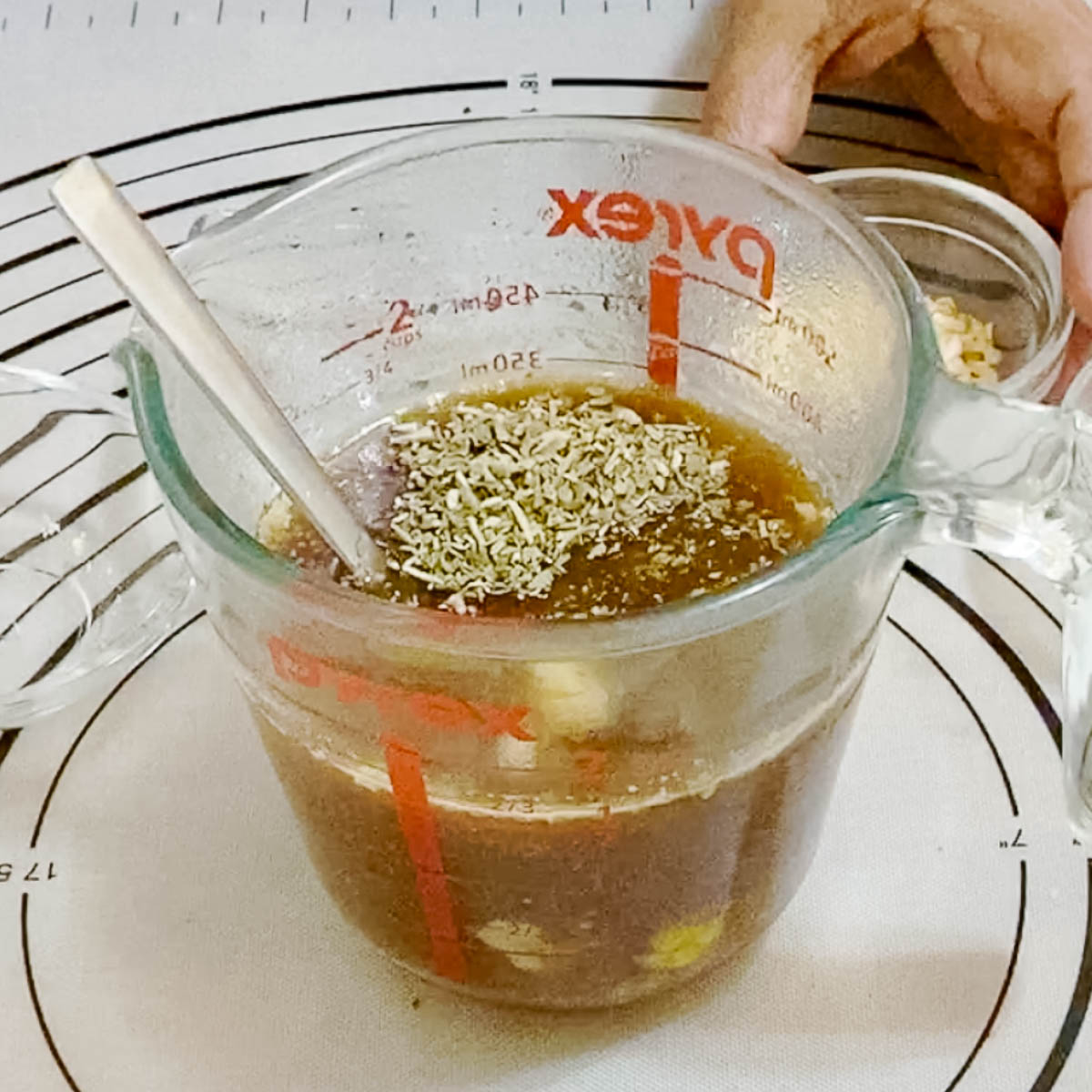 Shredded beef liquid in a measuring cup.