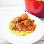 A serving plate with spaghetti and meatballs.