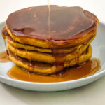 A stack of pumpkin pancakes on the plate.