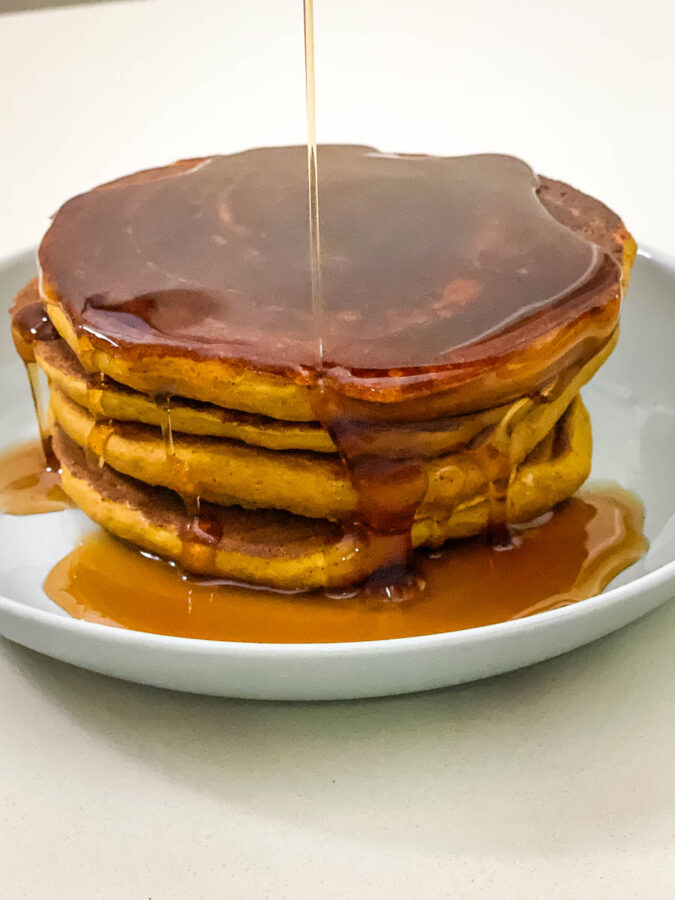A stack of pumpkin pancakes on the plate.