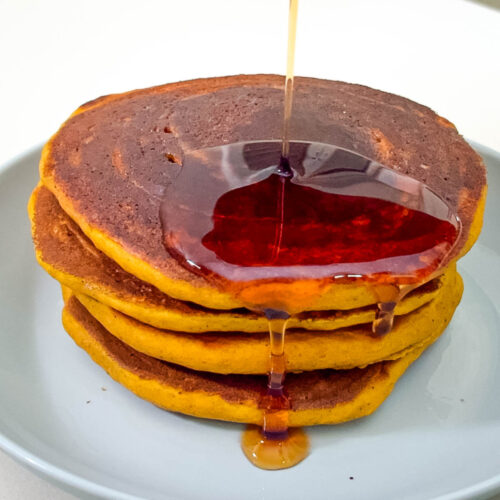 Stack of pumpkin pancakes on the table.