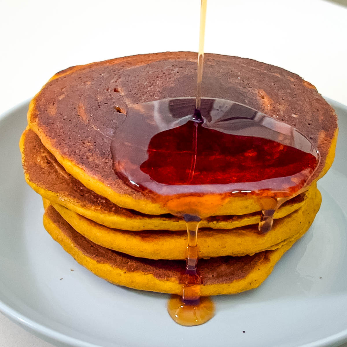 Stack of pumpkin pancakes on the table.