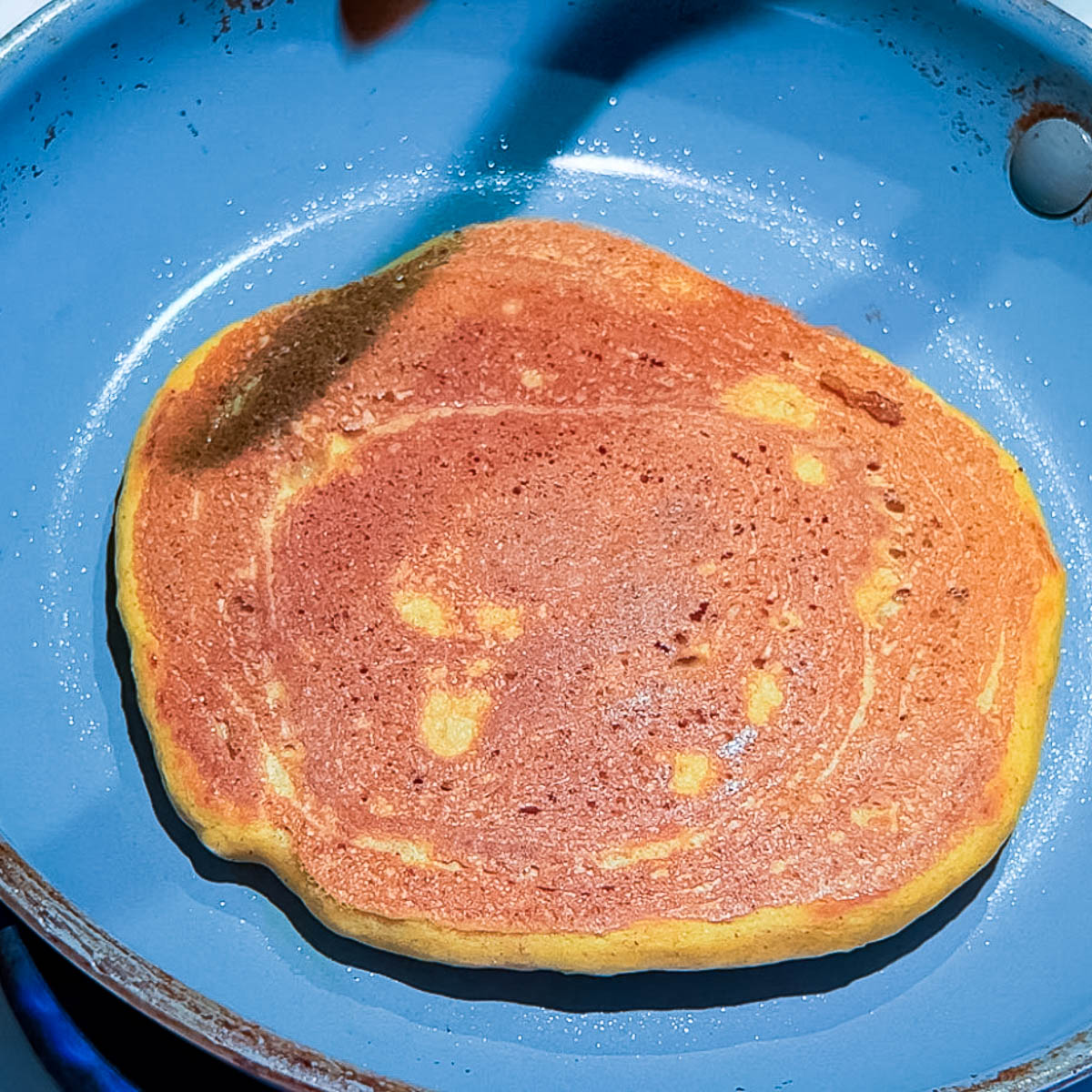 A frying pan with pancake.