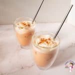 Two ice lattes with straws on display