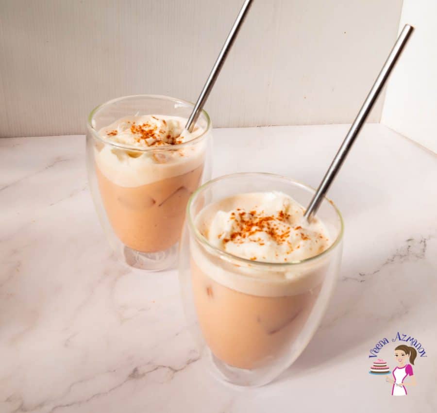 Two ice lattes with straws on display