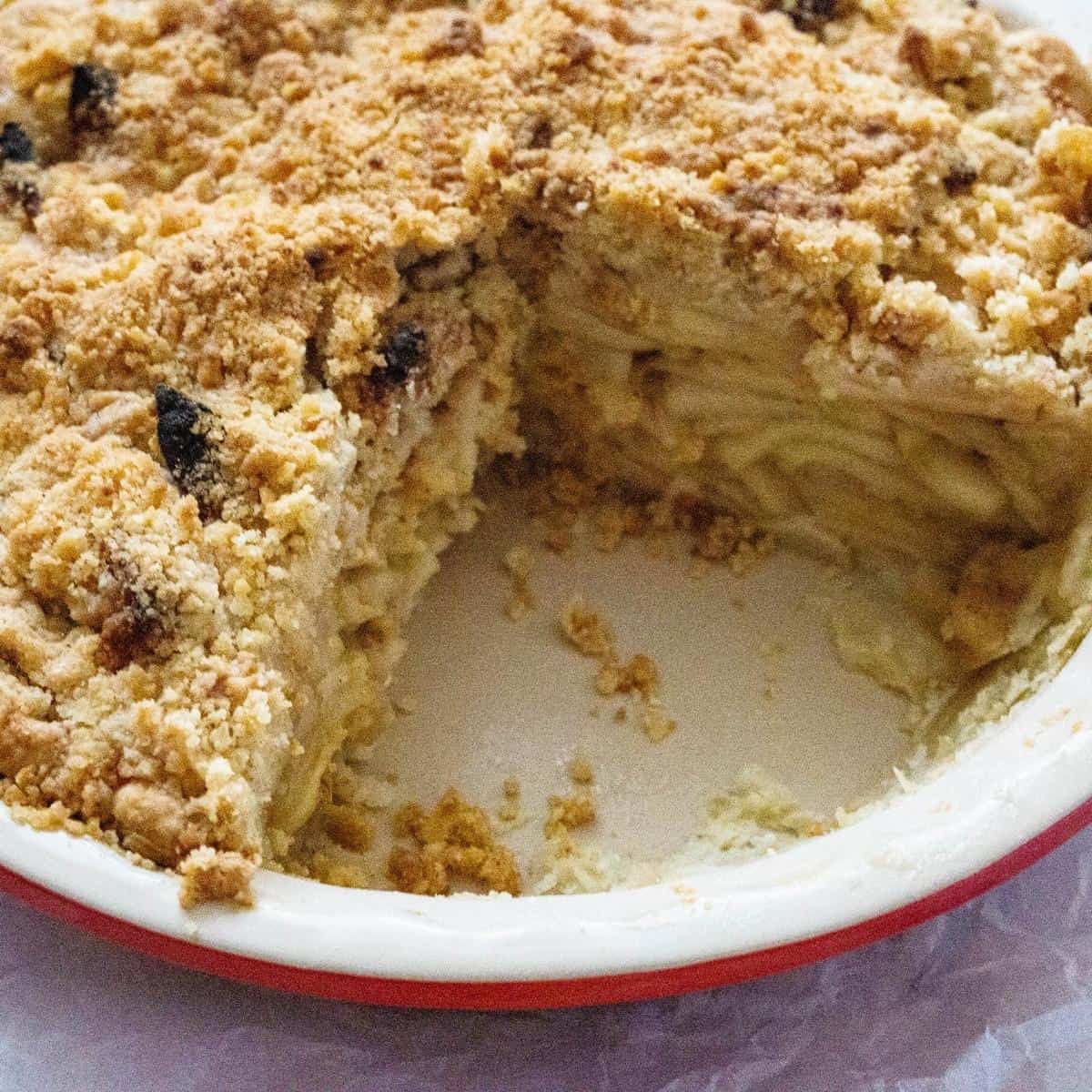 A sliced pie with apples and crumble.