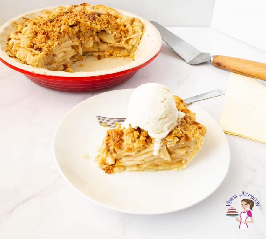 A pan with apple pie and a plate with a slice of the pie with vanilla ice cream on top.