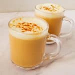 Two cups with chai tea latte.