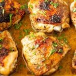 A ceramic dish with chicken thighs.