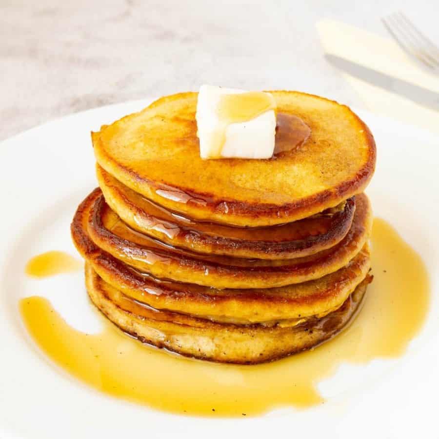 Stack of pancakes topped with butter