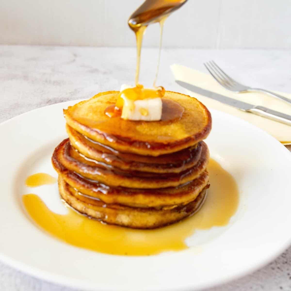 Stack of pancakes with maple syrup.