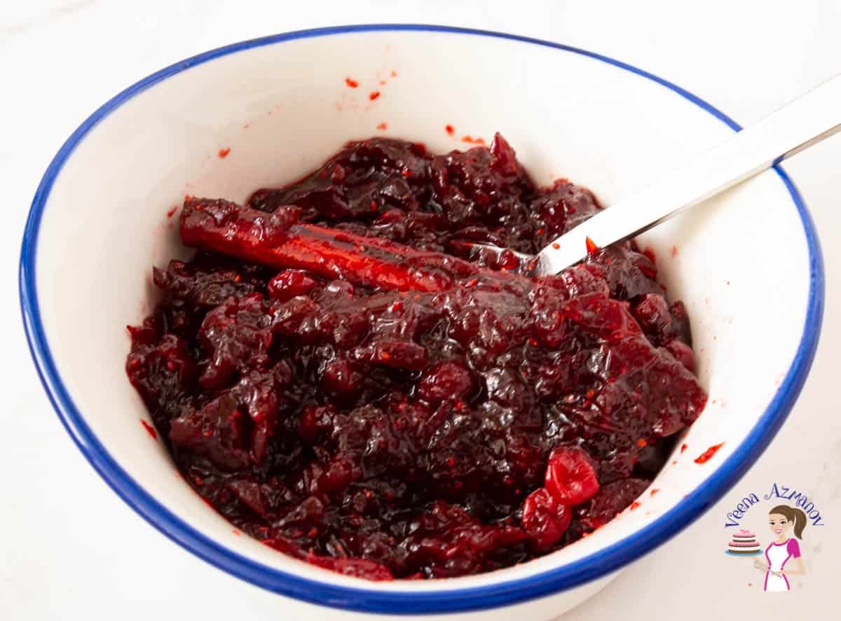 A white bowl with cranberry condiments