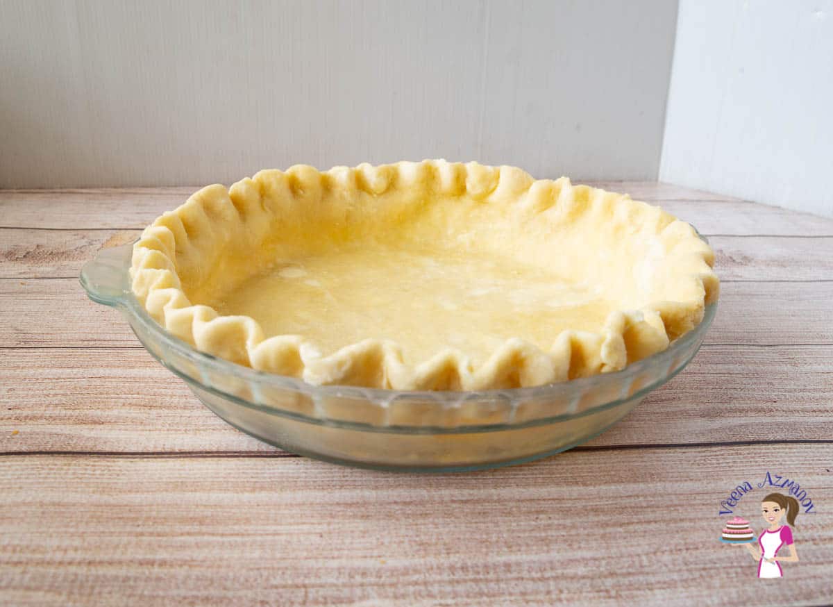 A crimped pie crust ready to be baked
