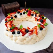 A pavlova on a cake stand.