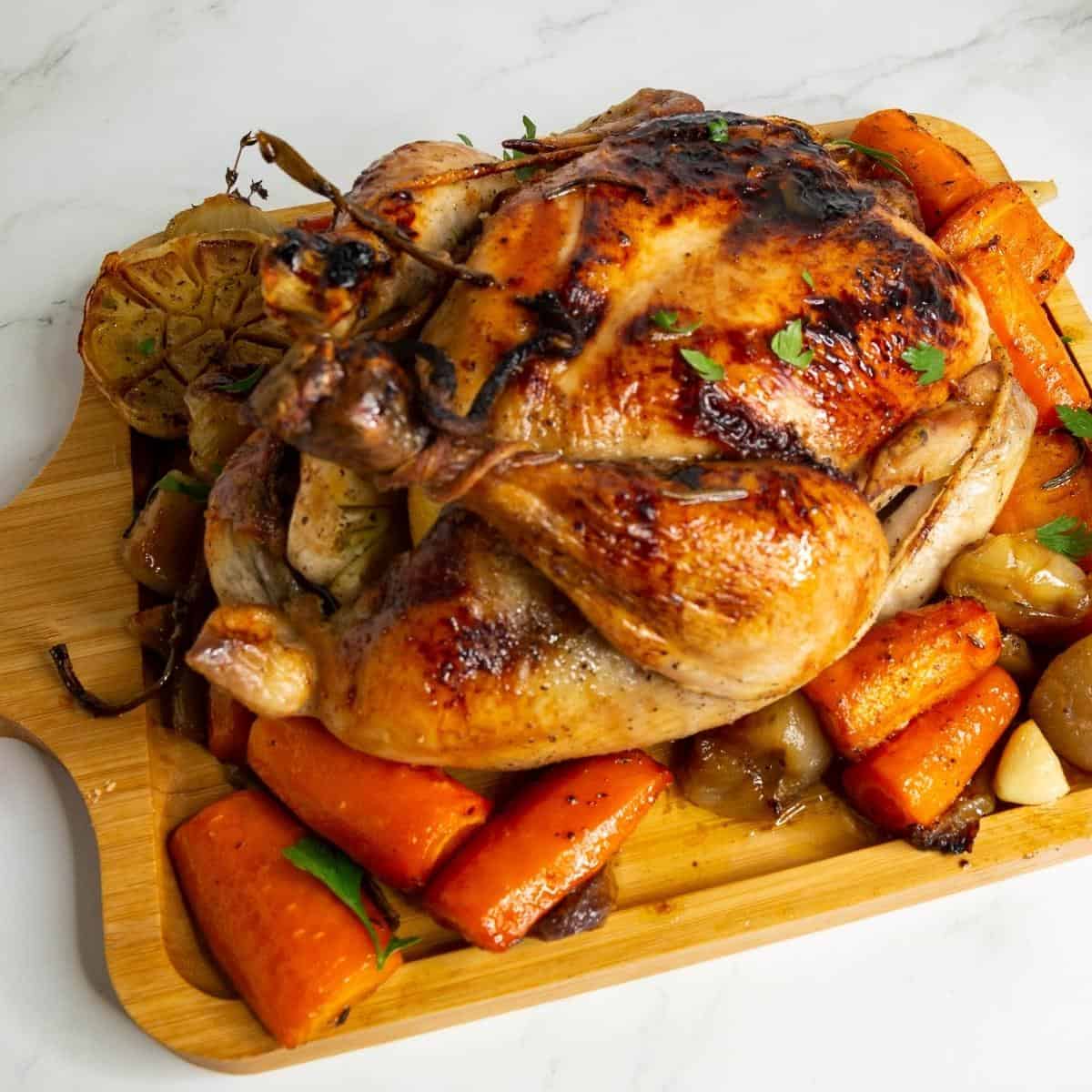 Roasted chicken with veggies on a serving platter.