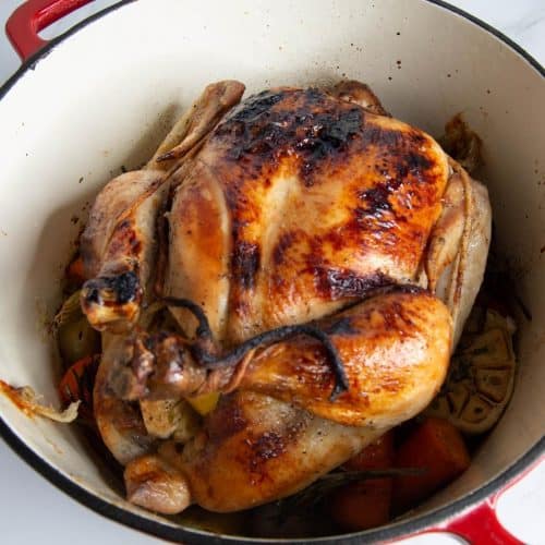 A roasted chicken in a dutch oven.