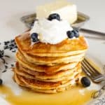 A plate with a stack of pancakes.