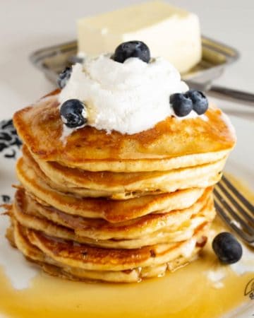 A plate with a stack of pancakes.